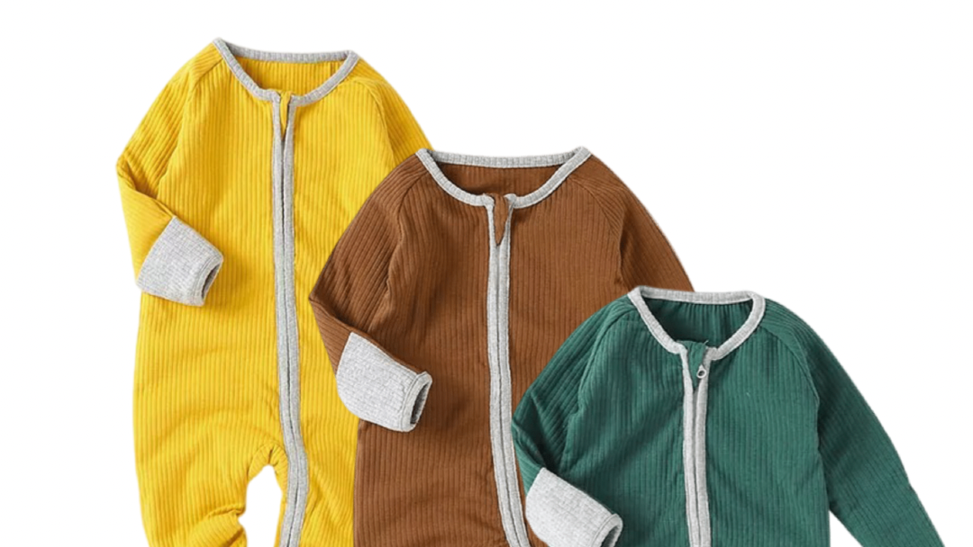 Three baby onesies in yellow, brown, and green on a white background